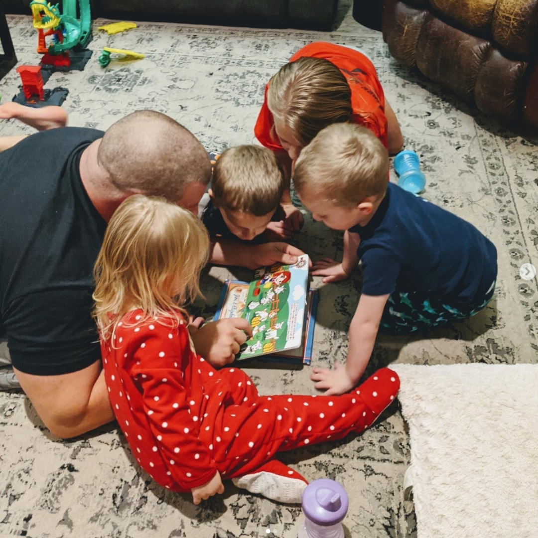 Group of young children and adult reading Farm Adventure Colors Book together. Interactive learning for kids ages 0-5.